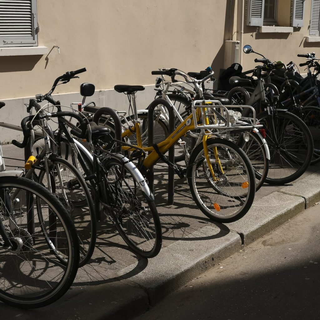 a row of bicycles parked next to a building