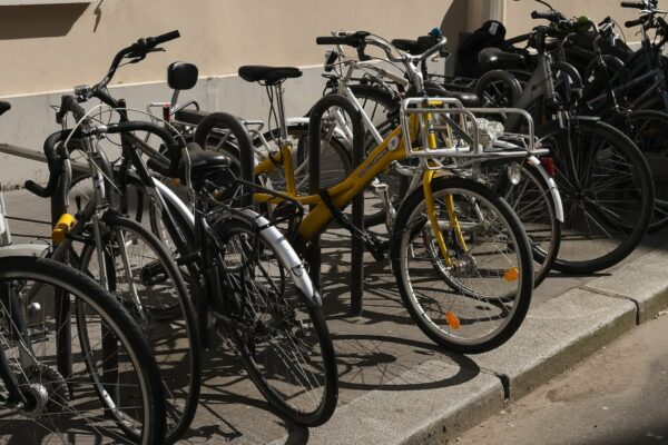 a row of bicycles parked next to a building