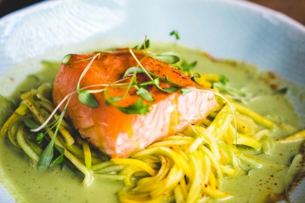 pasta with green leaf on white ceramic plate