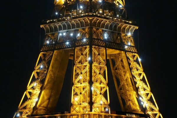 the eiffel tower is lit up at night